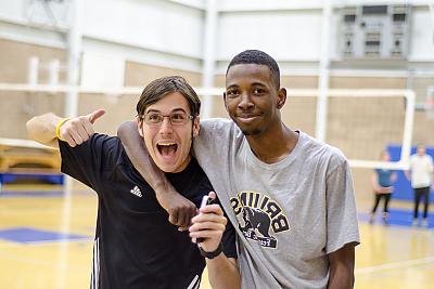 Two L和mark students pose for the camera during a volleyball game in the Click Family Athletic Center. 